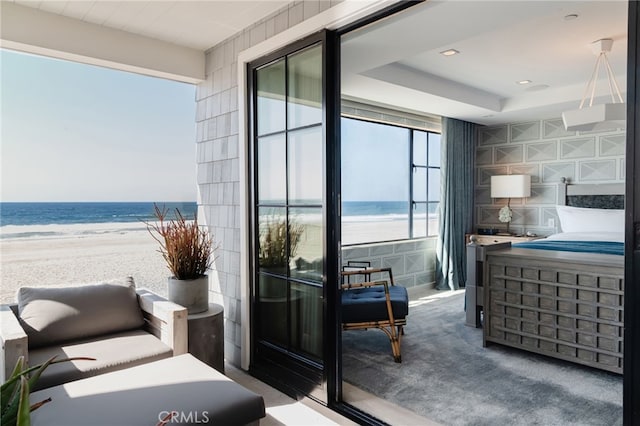 balcony with a water view and a beach view