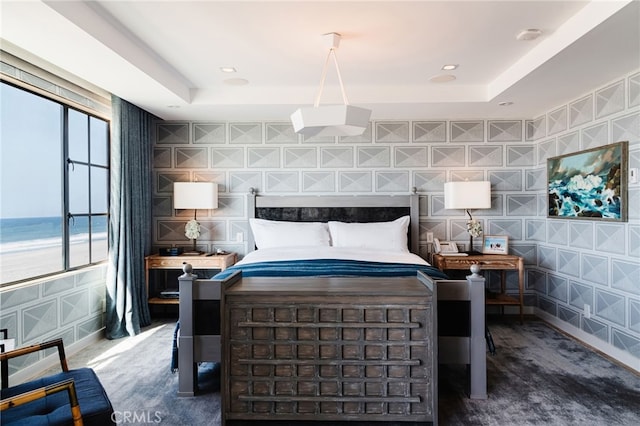 bedroom featuring wallpapered walls, baseboards, a tray ceiling, and recessed lighting