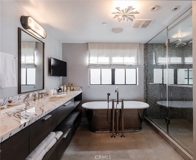 full bath featuring a shower stall, a soaking tub, vanity, and a wealth of natural light
