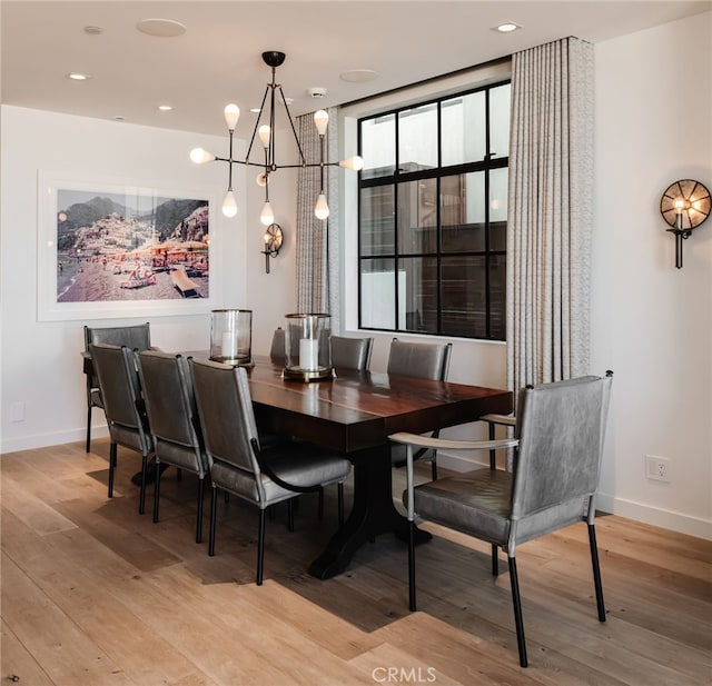 dining space with recessed lighting, light wood-type flooring, an inviting chandelier, and baseboards