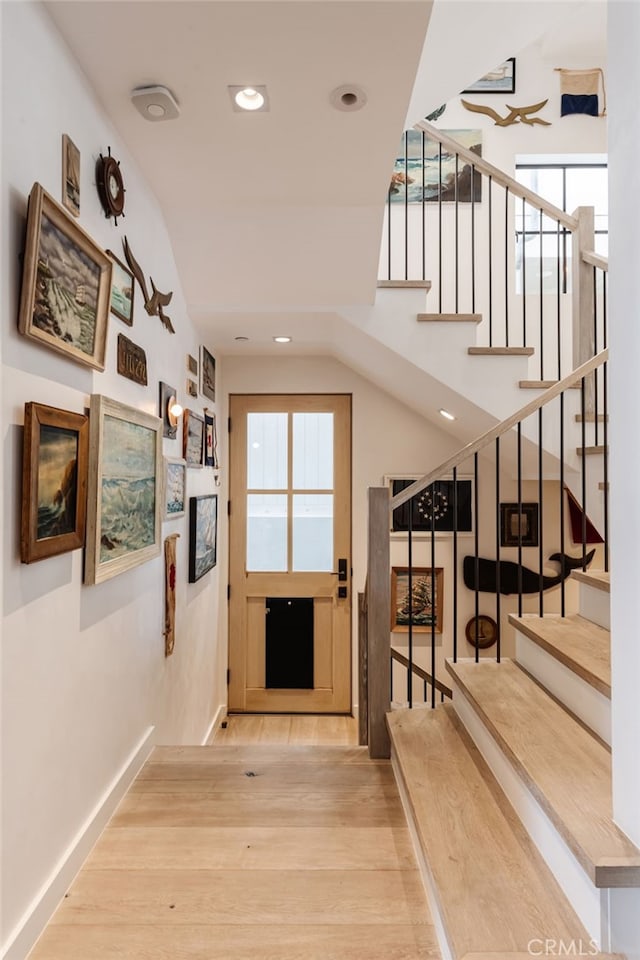 interior space with recessed lighting, stairway, baseboards, and wood finished floors