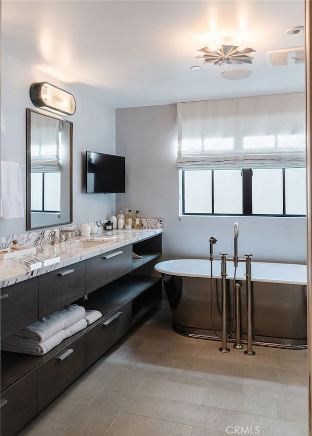 full bath with a soaking tub and vanity