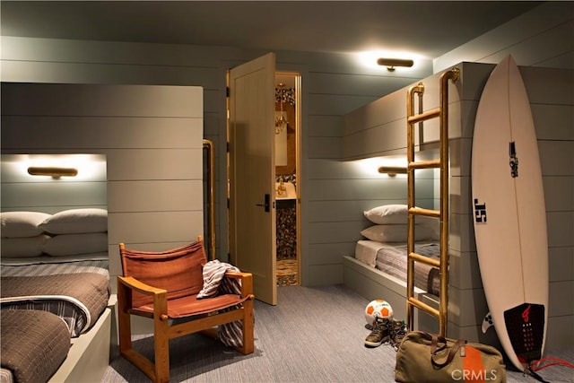 bedroom with wood walls and carpet
