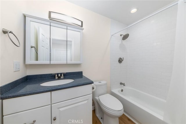 full bathroom with toilet, vanity, and washtub / shower combination