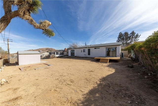 back of house with a fenced backyard