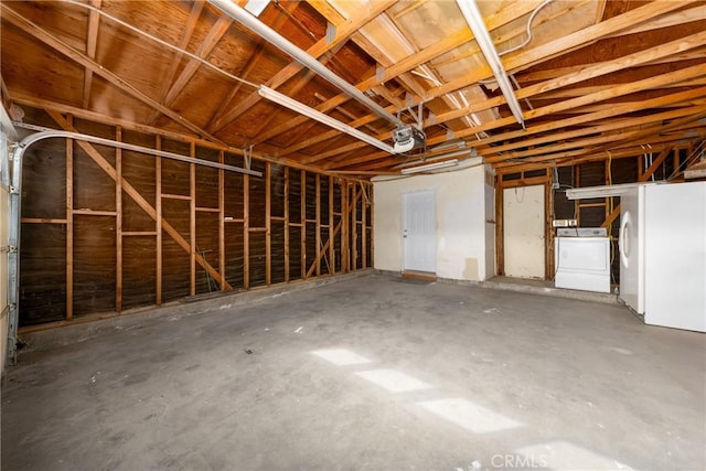 garage with washer / clothes dryer and a garage door opener