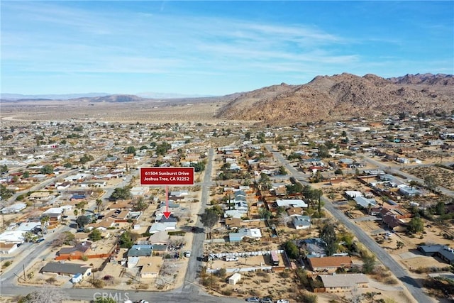 drone / aerial view featuring a residential view and a mountain view