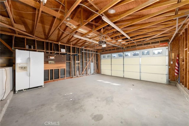 garage with white fridge with ice dispenser, independent washer and dryer, and a garage door opener