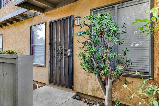 property entrance with stucco siding