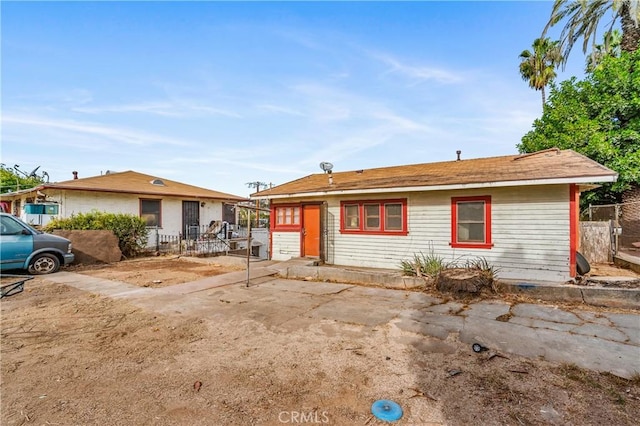 single story home featuring fence