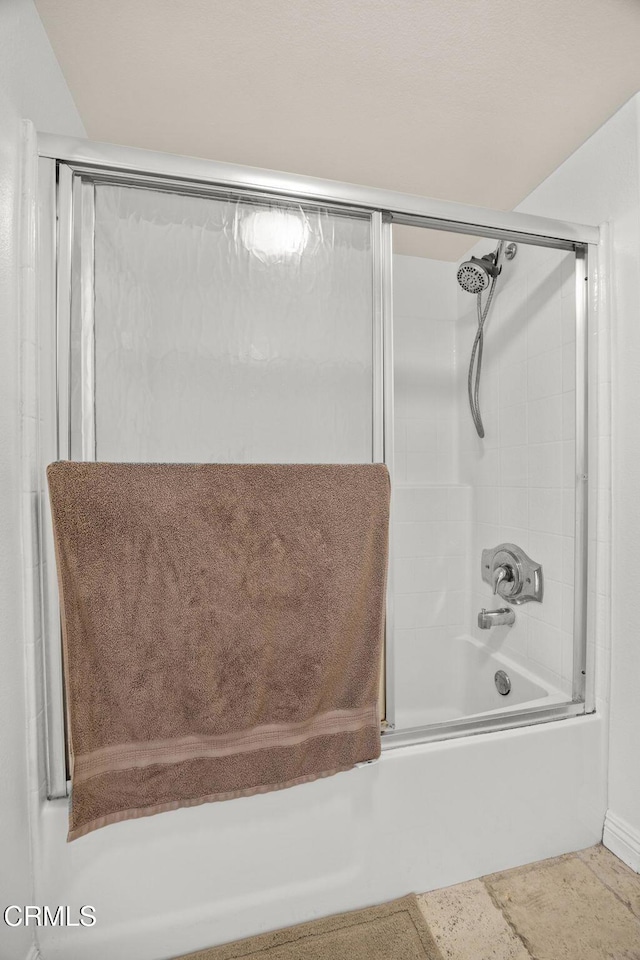 full bathroom with bath / shower combo with glass door