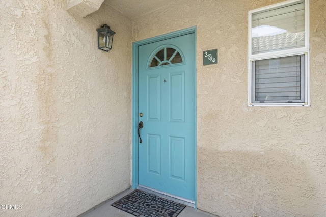 doorway to property with stucco siding