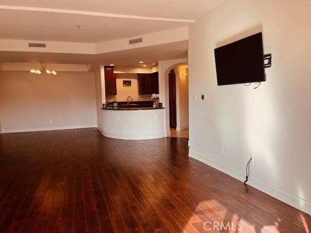 14242 Burbank Blvd Unit 103, Sherman Oaks, CA 91401 - unfurnished living room featuring arched walkways, dark wood-style flooring, and a chandelier