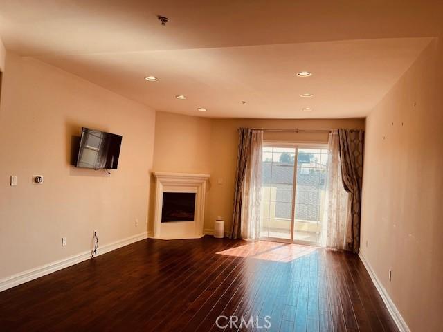 14242 Burbank Blvd Unit 103, Sherman Oaks, CA 91401 - unfurnished living room featuring dark wood-style floors, recessed lighting, and a fireplace