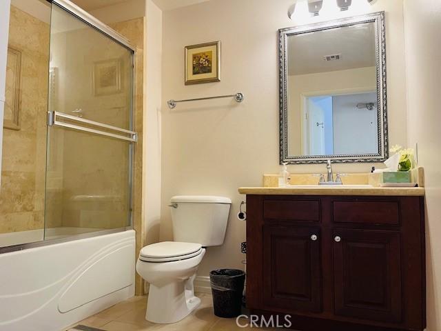 14242 Burbank Blvd Unit 103, Sherman Oaks, CA 91401 - bathroom with toilet, vanity, tile patterned floors, enclosed tub / shower combo, and baseboards
