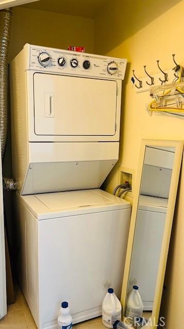14242 Burbank Blvd Unit 103, Sherman Oaks, CA 91401 - washroom featuring estacked washer and dryer and light tile patterned flooring