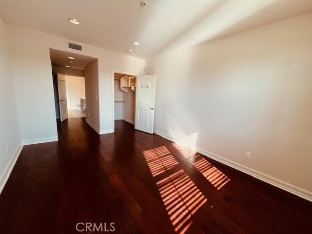 14242 Burbank Blvd Unit 103, Sherman Oaks, CA 91401 - unfurnished bedroom featuring wood finished floors, recessed lighting, a closet, and a walk in closet