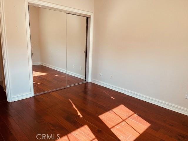 14242 Burbank Blvd Unit 103, Sherman Oaks, CA 91401 - unfurnished bedroom featuring wood finished floors, baseboards, and a closet
