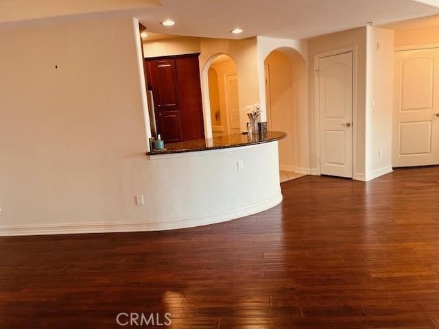 14242 Burbank Blvd Unit 103, Sherman Oaks, CA 91401 - unfurnished living room featuring dark wood-style floors, recessed lighting, and arched walkways