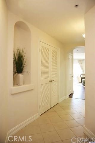 14242 Burbank Blvd Unit 103, Sherman Oaks, CA 91401 - hallway featuring arched walkways and light tile patterned flooring