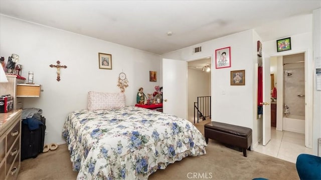 bedroom featuring light colored carpet, visible vents, and light tile patterned flooring