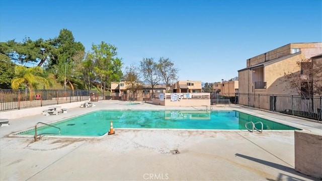 pool featuring a patio area and fence