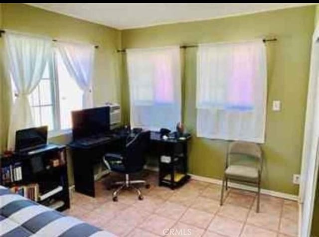 bedroom featuring tile patterned flooring and baseboards