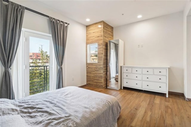 bedroom featuring access to outside, baseboards, light wood-style flooring, and recessed lighting