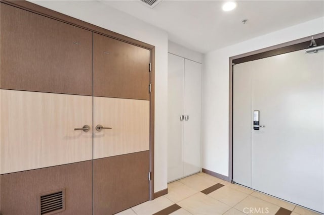 interior space featuring visible vents, baseboards, and light tile patterned floors