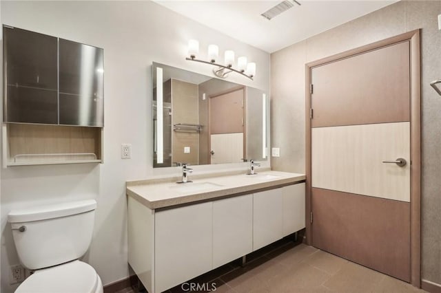 full bathroom with visible vents, a sink, toilet, and double vanity