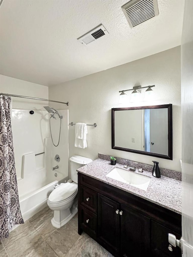 bathroom with a textured ceiling, shower / bath combo, vanity, and visible vents