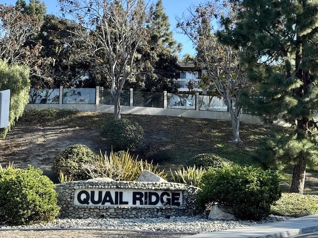 community sign featuring fence