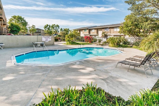 pool featuring a patio area and fence