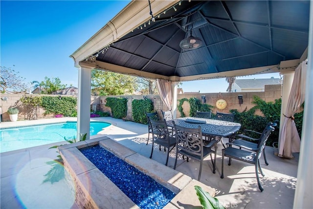 view of patio featuring a gazebo, a fenced backyard, and a fenced in pool