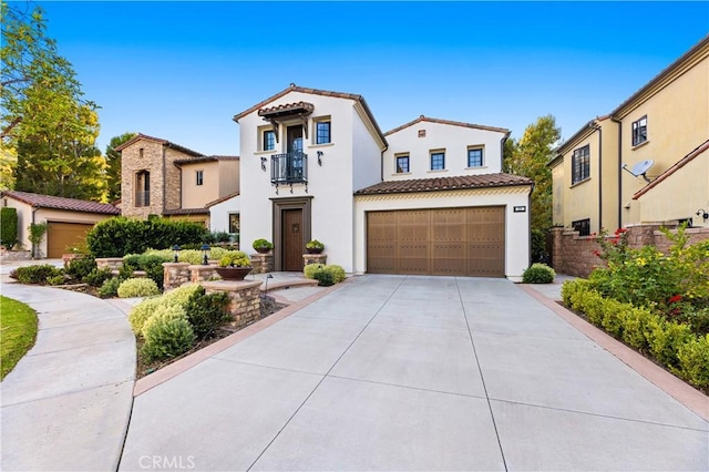 mediterranean / spanish-style house with driveway, a tiled roof, a residential view, and a balcony