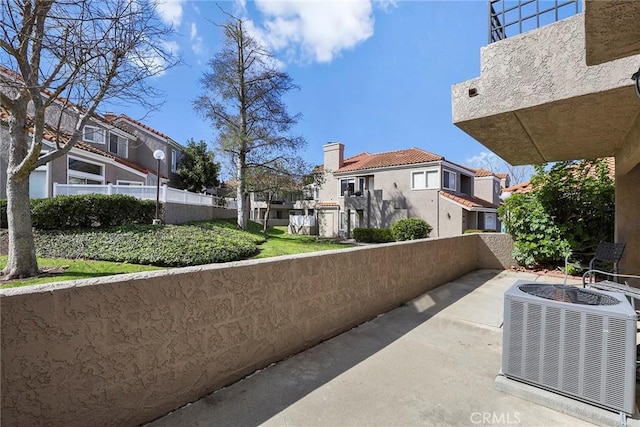 exterior space with a residential view, a patio, and central AC