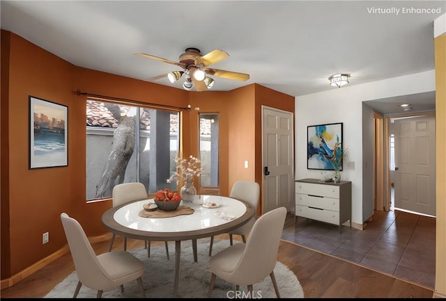 dining area featuring wood finished floors, baseboards, and ceiling fan