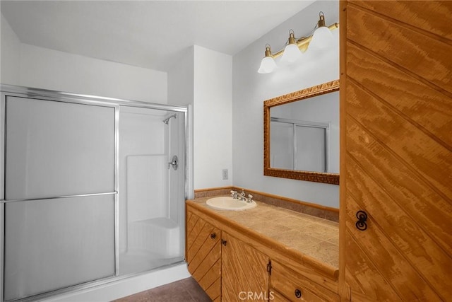 bathroom featuring a stall shower and vanity
