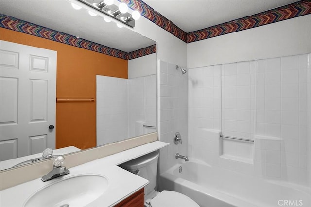 bathroom with vanity, shower / tub combination, and toilet