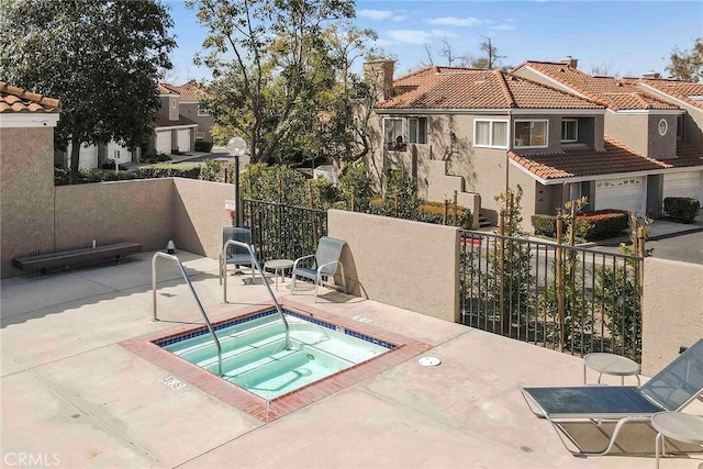 view of swimming pool with a patio area, a hot tub, and fence