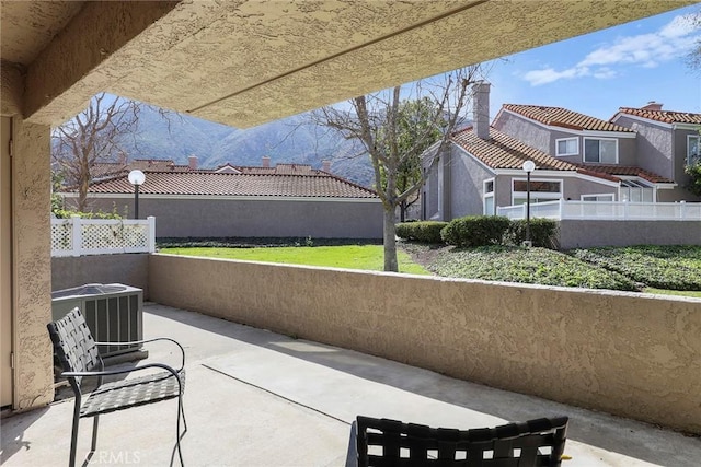 view of patio featuring cooling unit and fence