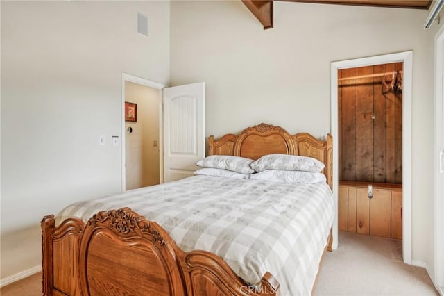 bedroom featuring light carpet, vaulted ceiling, and visible vents