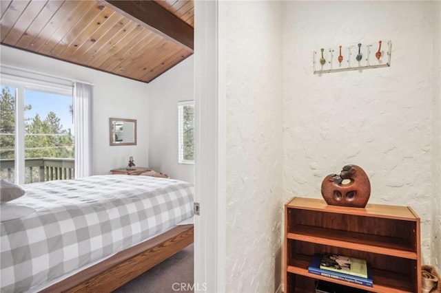 bedroom featuring wooden ceiling, a textured wall, and lofted ceiling with beams