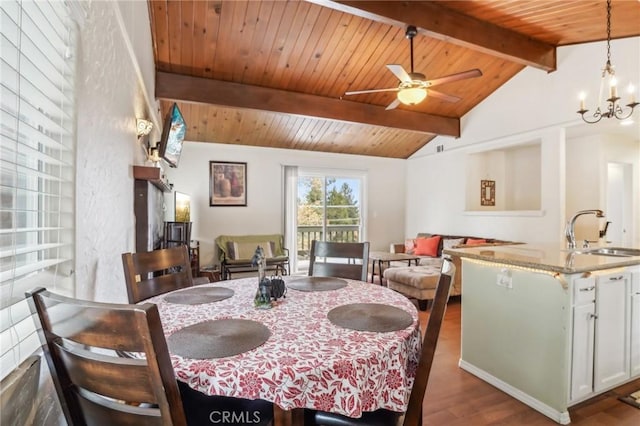 dining room with ceiling fan with notable chandelier, wooden ceiling, vaulted ceiling with beams, and wood finished floors