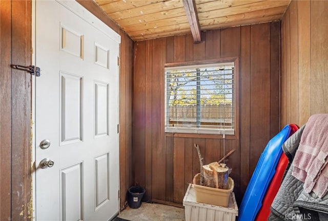 interior space featuring wood ceiling, wooden walls, and beamed ceiling