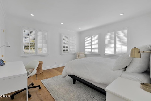 bedroom with recessed lighting, baseboards, and light wood finished floors