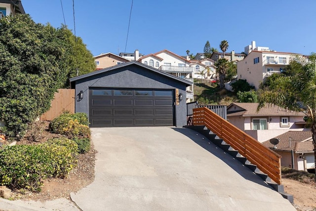 view of front of home featuring stucco siding, a residential view, and concrete driveway