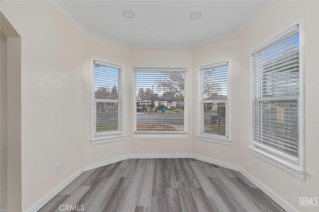 interior space featuring baseboards and wood finished floors