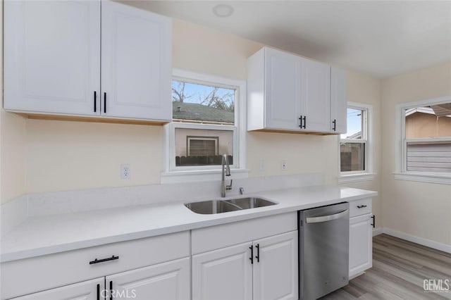 kitchen with a sink, light countertops, and dishwasher