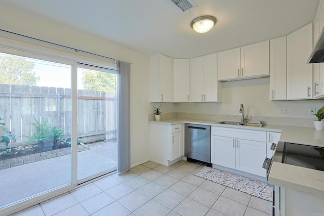 kitchen featuring visible vents, white cabinets, stainless steel appliances, light countertops, and a sink